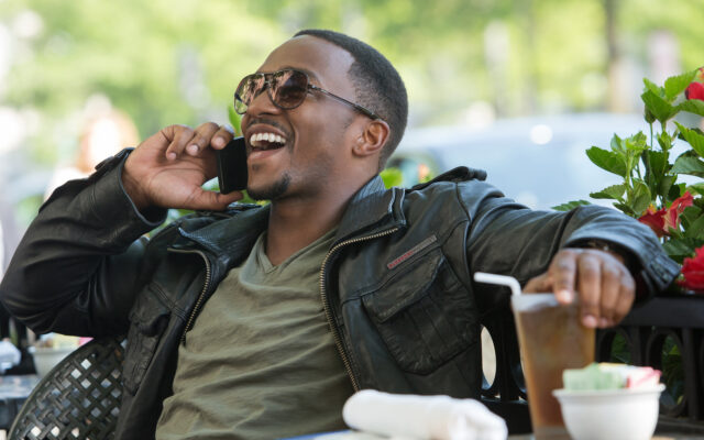 Anthony Mackie Smiling On Phone Relaxed Mood Wallpaper
