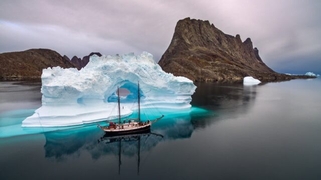 Arctic Ocean Wallpapers Stunning Iceberg And Sailboat With Mountain Reflection In Calm Waters