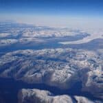 Arctic Ocean Aerial View With Snow Covered Islands And Deep Blue Waters Wallpaper