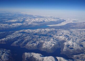 Arctic Ocean Aerial View With Snow Covered Islands And Deep Blue Waters Wallpaper