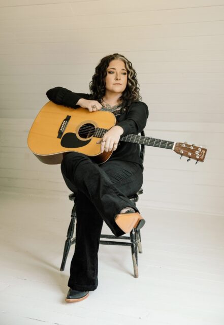 Ashley McBryde With Acoustic Guitar Elegant Wallpaper