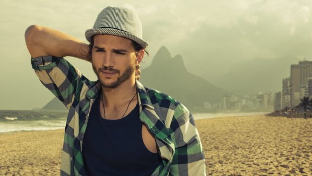 Ashton Kutcher Casual Beach Look In Stylish Hat And Plaid Shirt Wallpapers
