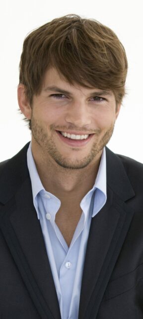 Ashton Kutcher Smiling In A Sharp Suit Professional Portrait Wallpaper