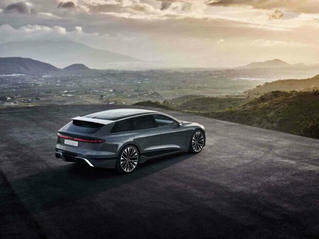 The Audi A6 is parked on a mountain road overlooking a vast valley under a cloudy sky, HD Desktop Wallpaper
