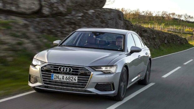 A silver Audi A6 drives along a winding rural road with a driver inside, HD Desktop Wallpaper