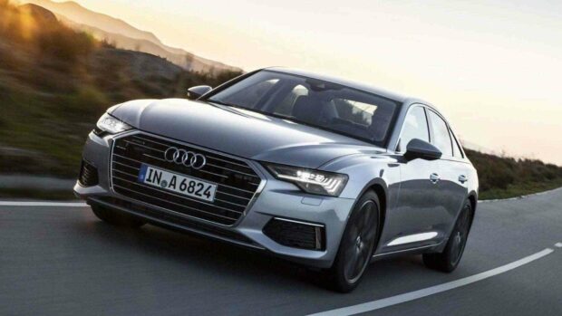 The Audi A6 is shown driving along a curvy road during sunset, HD Desktop Wallpaper