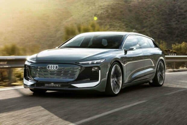 A sleek Audi A6 electric model is driving smoothly along a curved mountain road, showcasing modern design and innovation, HD Desktop Wallpaper
