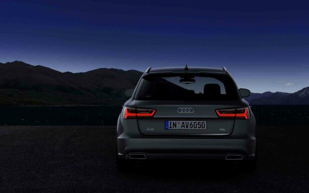 The Audi A6 is parked facing a lake with mountains in the background during nighttime, 2K Desktop Wallpaper