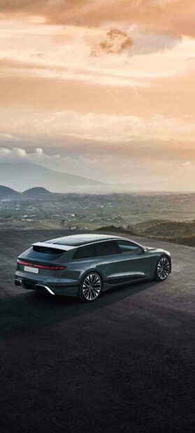 A dark gray Audi A6 car parked on a mountain road with a scenic cloudy sky in the background, HD Phone Wallpaper