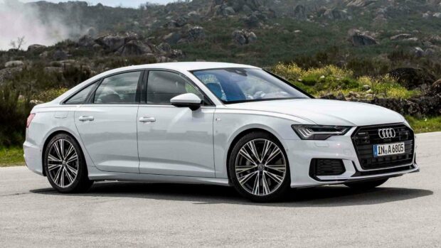 A white Audi A6 is parked on a paved road with a mountainous background, HD Desktop Wallpaper