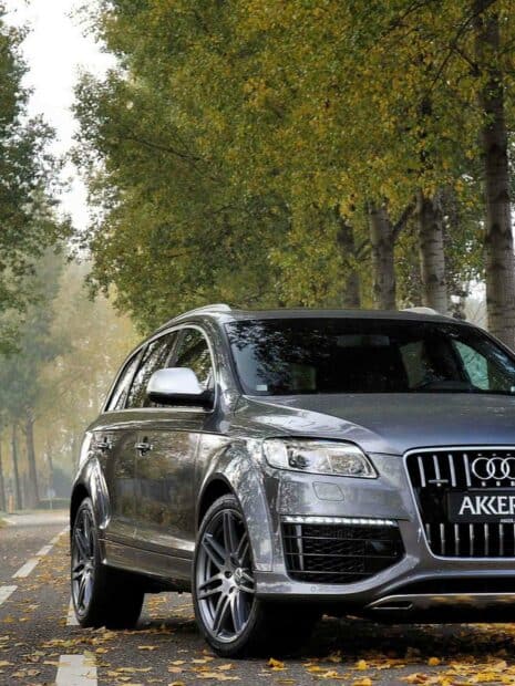 A gray Audi Q7 drives along a tree lined road covered with fallen leaves, HD Desktop Wallpaper