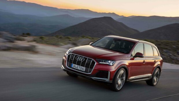 A red Audi Q7 drives along a winding mountain road during sunset, 4K Desktop Wallpaper