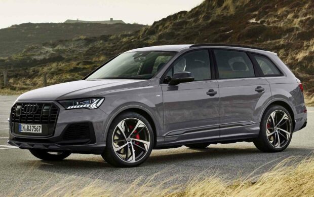 A grey Audi Q7 parked on a road with a grassy hill background, HD Desktop Wallpaper