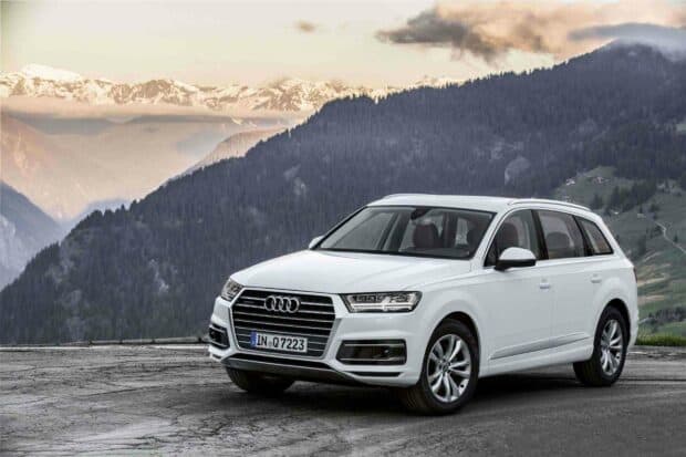 A white Audi Q7 is parked on a mountain road with snowy peaks in the background, HD Desktop Wallpaper