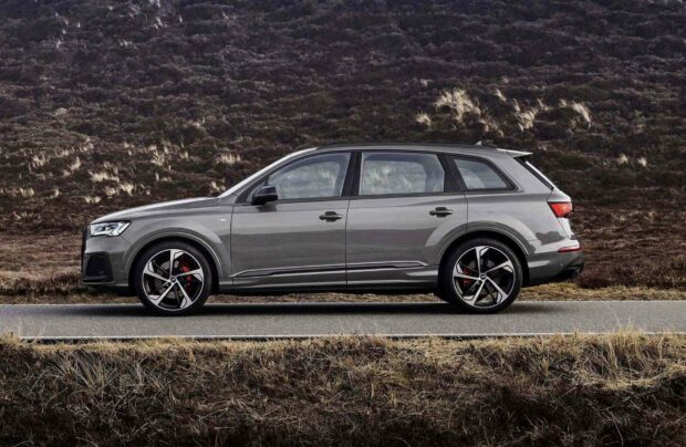 A gray Audi Q7 is parked on a road with a rough landscape in the background, HD Desktop Wallpaper