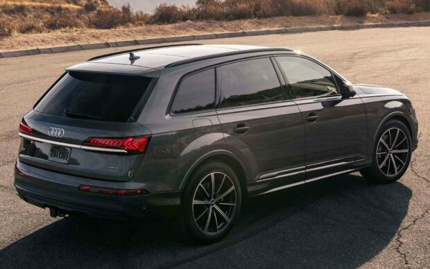 A dark gray Audi Q7 is parked on a curved road with clear details of the rear and side visible, HD Desktop Wallpaper