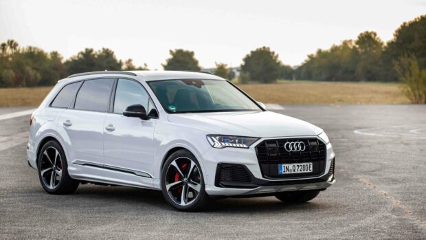 A white Audi Q7 is parked on a paved area with trees in the background under a clear sky, 4K Desktop Wallpaper