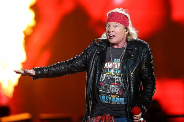 Axl Rose is singing with a red bandana and leather jacket on stage, HD Desktop Wallpaper