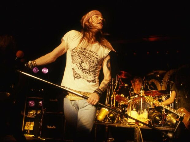 Axl Rose is passionately singing during a concert performance, HD Desktop Wallpaper