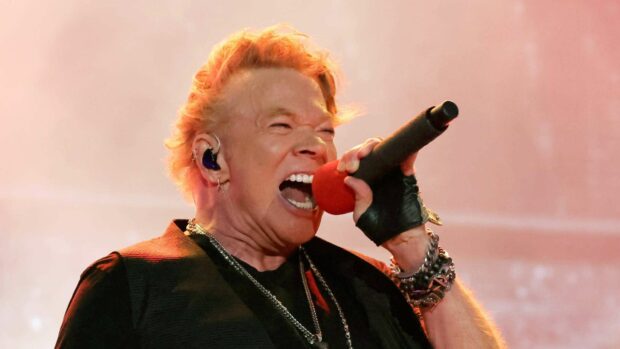 Axl Rose passionately sings into a microphone during a live performance, HD Desktop Wallpaper
