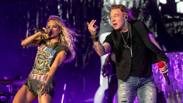 Axl Rose is singing energetically with a female performer during a live concert, HD Desktop Wallpaper