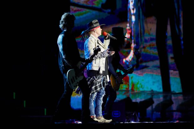 Axl Rose performing live with his band during a concert, 2K Desktop Wallpaper