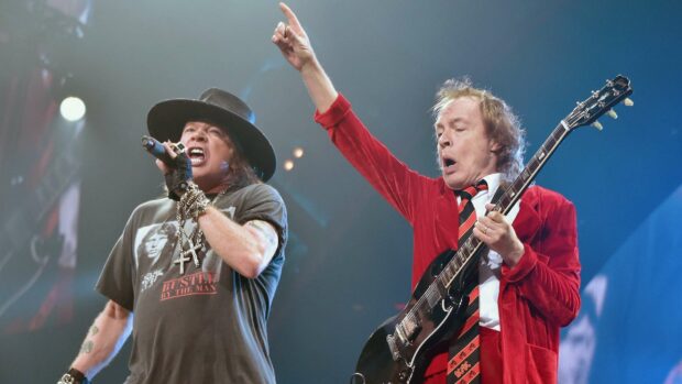 Axl Rose is singing passionately during a live concert performance, 2K Desktop Wallpaper