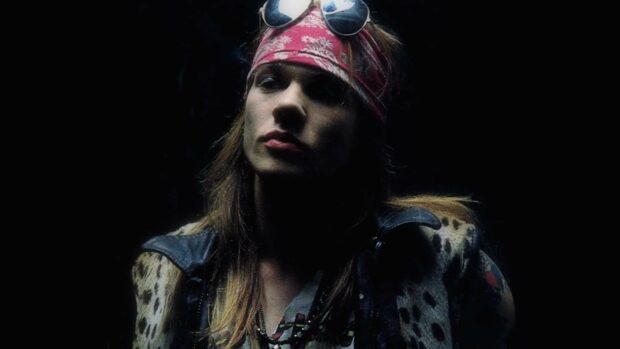 Axl Rose is wearing a red bandana and a leather jacket in a dark setting, HD Desktop Wallpaper