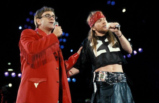 Axl Rose singing with a musician in a live concert setting, HD Desktop Wallpaper
