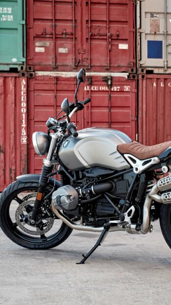 A BMW R Nine T motorcycle is parked in front of red shipping containers, HD Mobile Wallpaper
