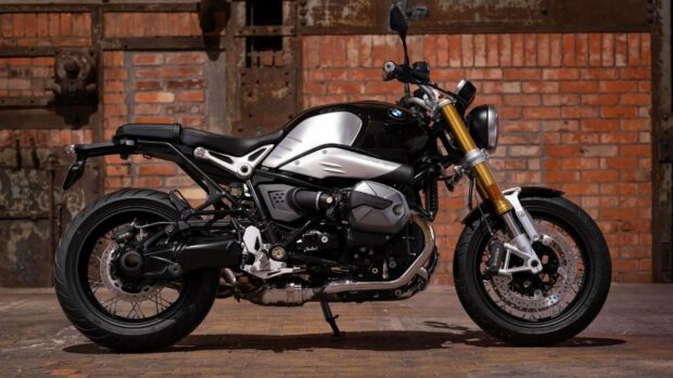 A black and silver BMW R Nine T motorcycle parked on a brick floor with a brick wall background, HD Desktop Wallpaper