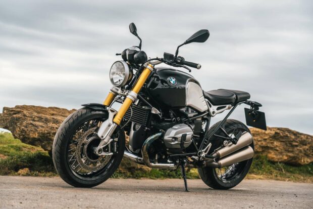 A black BMW R Nine T motorcycle parked on a road with rocks in the background, HD Desktop Wallpaper