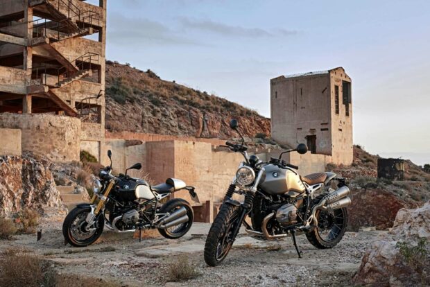 Two BMW R Nine T motorcycles stand against a backdrop of rocky hills and old concrete structures, HD Desktop Wallpaper