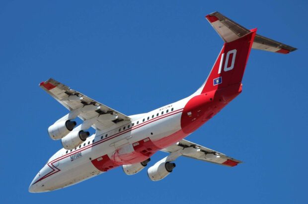 A Bae Avro airplane with red and white colors flies high in a clear blue sky, HD Desktop Wallpaper