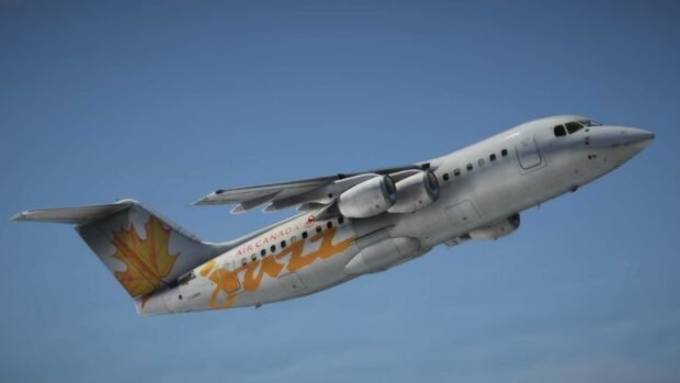 A Bae Avro airplane with Air Canada Jazz livery is captured flying in a clear blue sky, HD Desktop Wallpaper