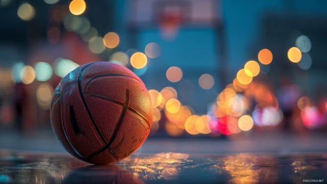 Basketball Desktop Wallpaper Free Download, A Captivating Shot Of A Basketball Rolling Towards The Net With Blurred Lights