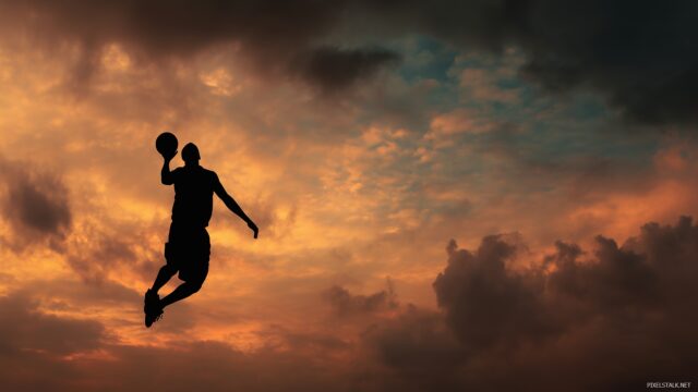 Basketball Wallpaper High Resolution, A Dramatic Sky Backdrop Behind A Silhouetted Basketball Player In Mid Air