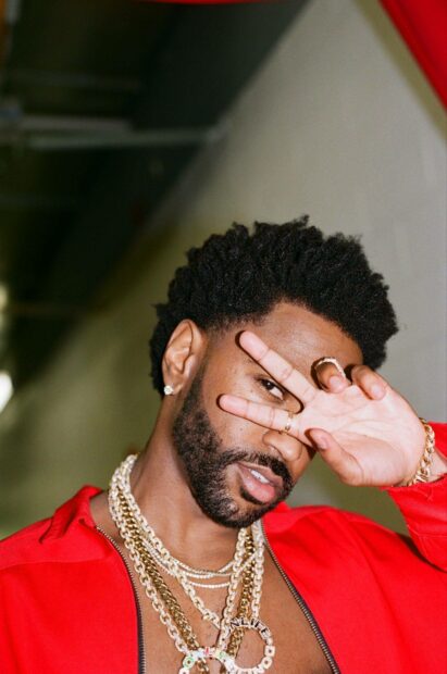 Big Sean wears layered gold chains and a red jacket while posing with his hand near his face, HD Mobile Wallpaper