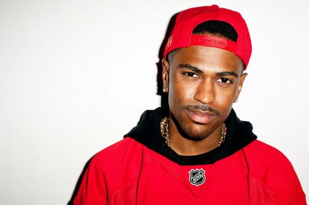Big Sean wears a red cap and jersey looking confidently at the camera, HD Desktop Wallpaper