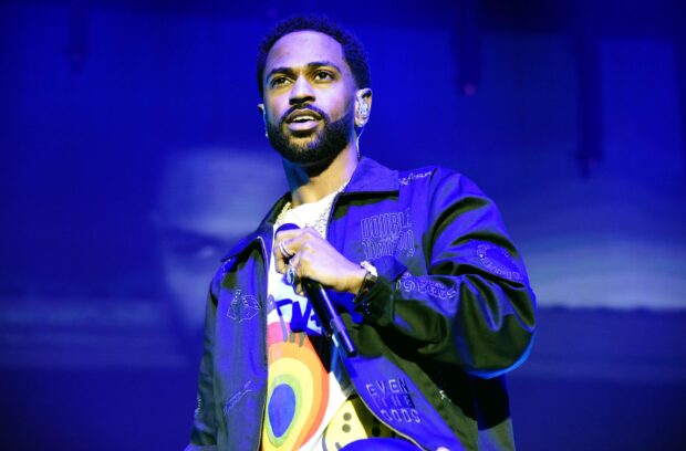 Big Sean captivates the audience during a live stage performance with vibrant lighting, 2K Desktop Wallpaper