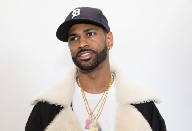 Big Sean is wearing a black cap and layered gold necklaces in this stylish portrait, 2K Desktop Wallpaper