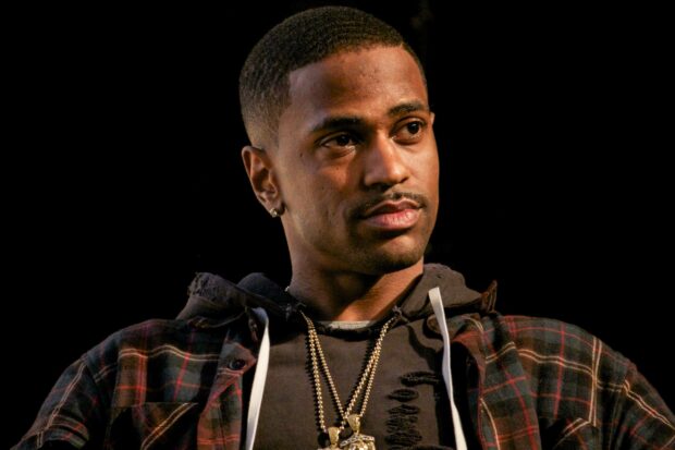 A close up of Big Sean wearing a plaid shirt and layered necklaces looking thoughtful, 2K Desktop Wallpaper