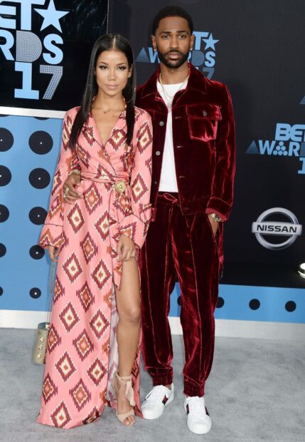 Big Sean standing in a red velvet suit with a woman in a patterned pink dress at the BET Awards event, HD Mobile Wallpaper