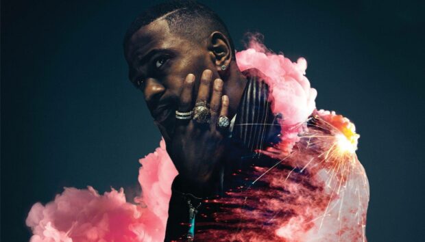 A thoughtful Big Sean surrounded by colorful smoke and sparks, HD Desktop Wallpaper