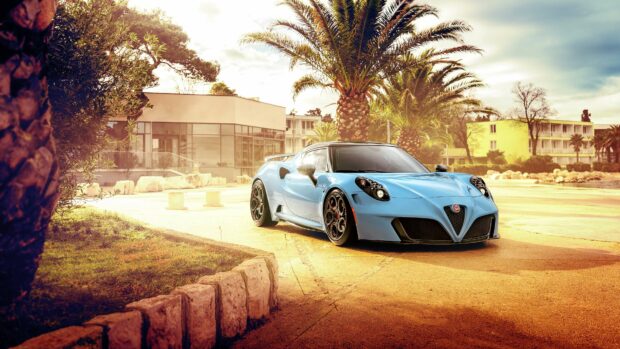 A blue Alfa Romeo sports car is parked on a sunlit street lined with palm trees and buildings in the background