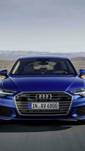A blue Audi A6 is driving forward on a paved road with mountains in the background, HD Mobile Wallpaper