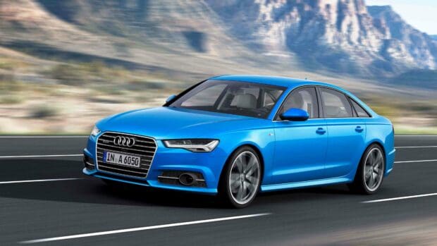 A blue Audi A6 is driving fast on a highway with mountains in the background, 4K Desktop Wallpaper