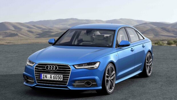 A blue Audi A6 is parked on a paved surface with hills in the background, 4K Desktop Wallpaper