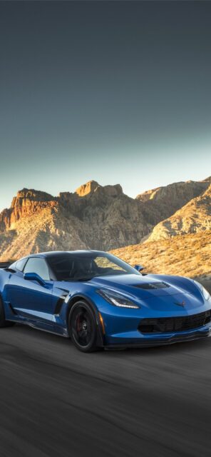 Blue Chevrolet Corvette Speeding On Mountain Road Perfect Wallpaper Background