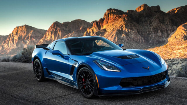 Blue Chevrolet Corvette Sports Car Wallpaper With Mountain Background At Sunset